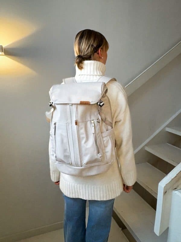 Person wearing a white NayoSmart travel backpack